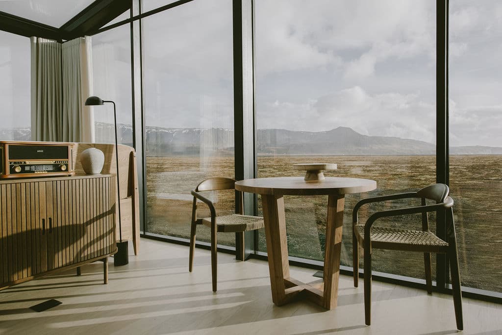 Dining area with large floor-to-ceiling windows showcasing mountain views in Rafter Seljalandsfoss Georg, Hvolsvöllur