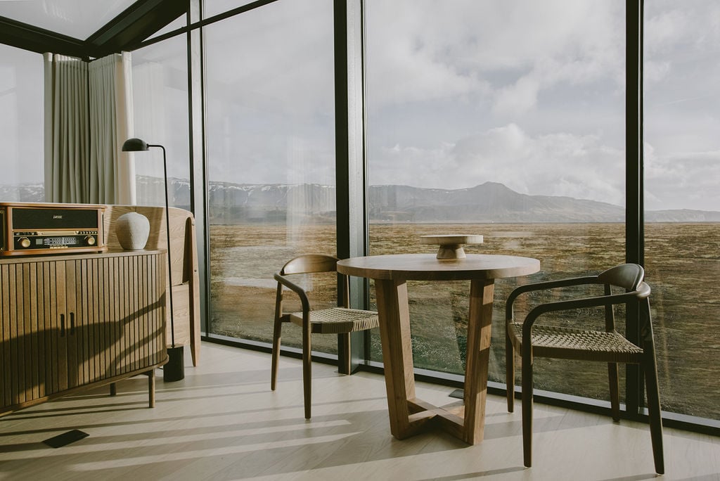 Dining area with large floor-to-ceiling windows showcasing mountain views in Rafter Seljalandsfoss Georg, Hvolsvöllur