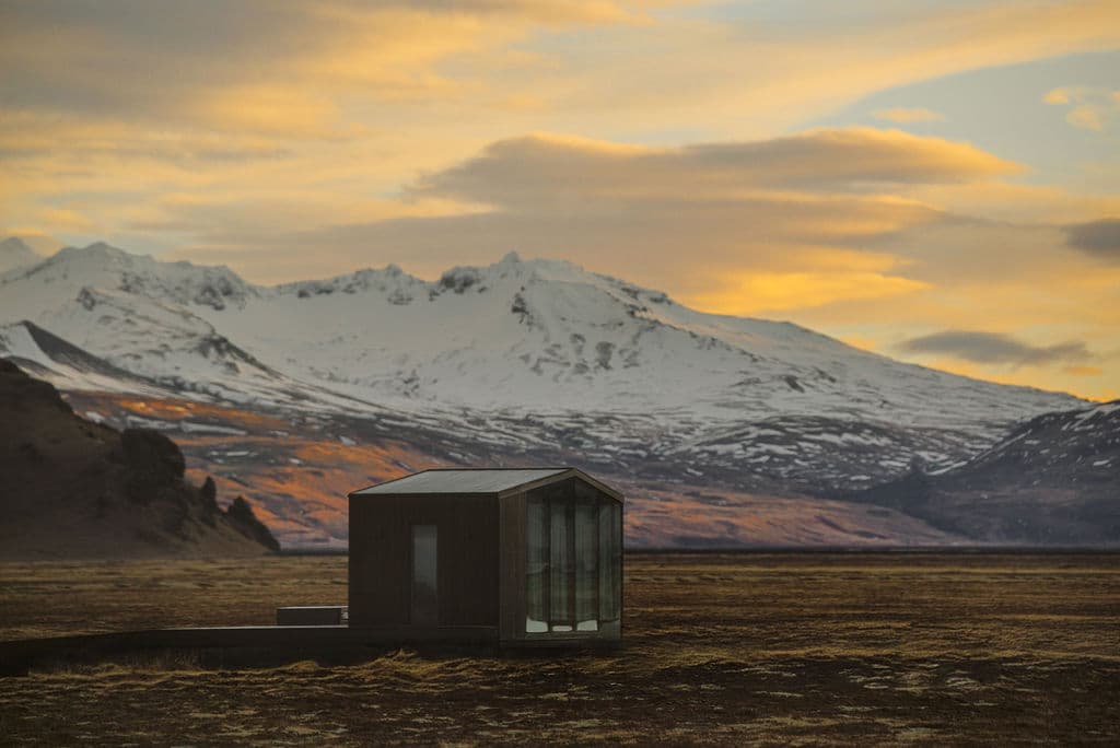 Remote cabin at Rafter Seljalandsfoss Lilja with large windows overlooking snowy mountains in Hvolsvöllur, Iceland
