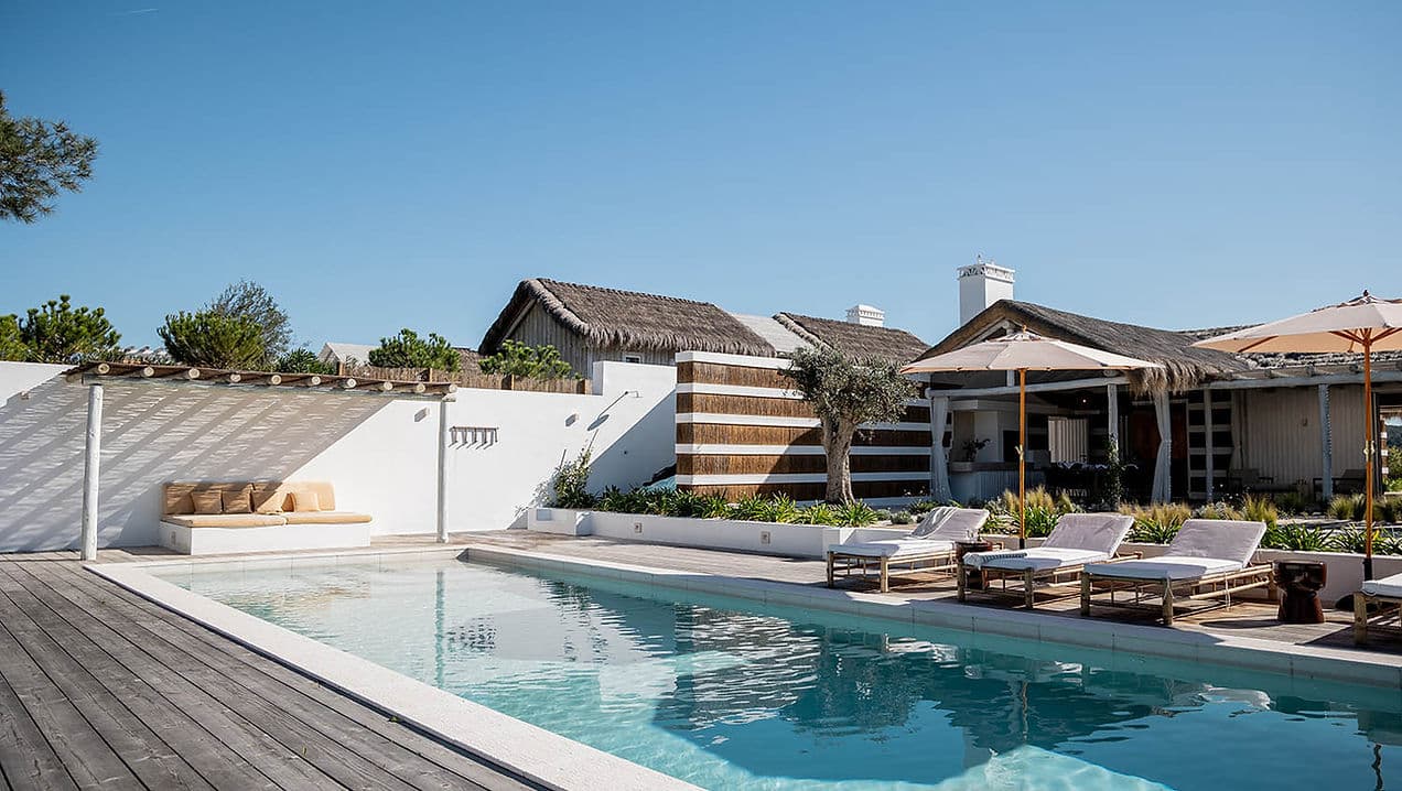 Outdoor pool area with sun loungers and umbrellas at Casa AHA at Casa AHA!, Carvalhal / Comporta