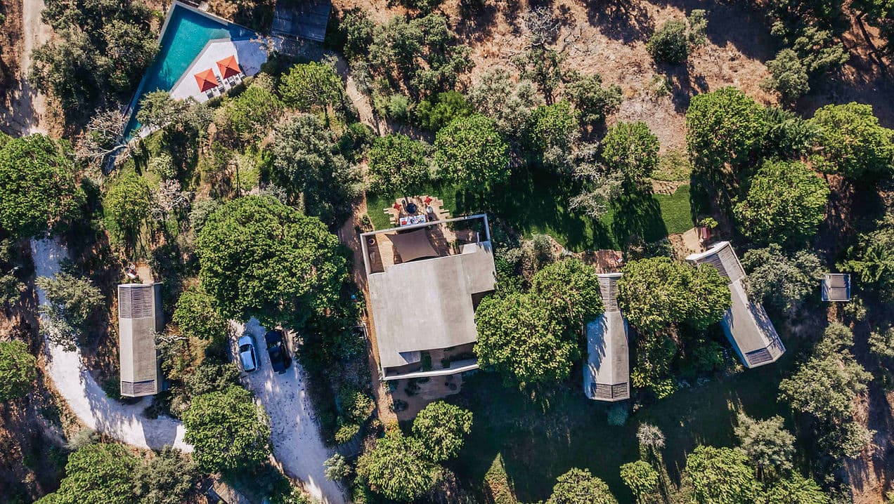Aerial view of Rafter Melides Atlantica showing multiple buildings, shaded outdoor seating, and pool in Melides, Portugal