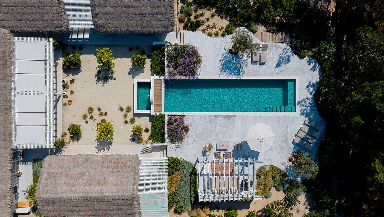 Aerial view of outdoor pool and sun loungers at Rafter Comporta Celeste in Comporta, Portugal