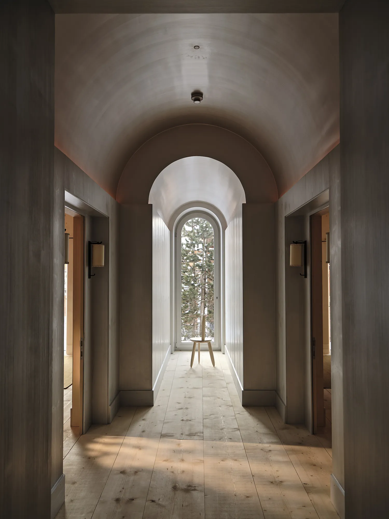 Hallway with arched ceiling and window view of trees at Rafter Lech Zug in Lech, Austria holiday rental